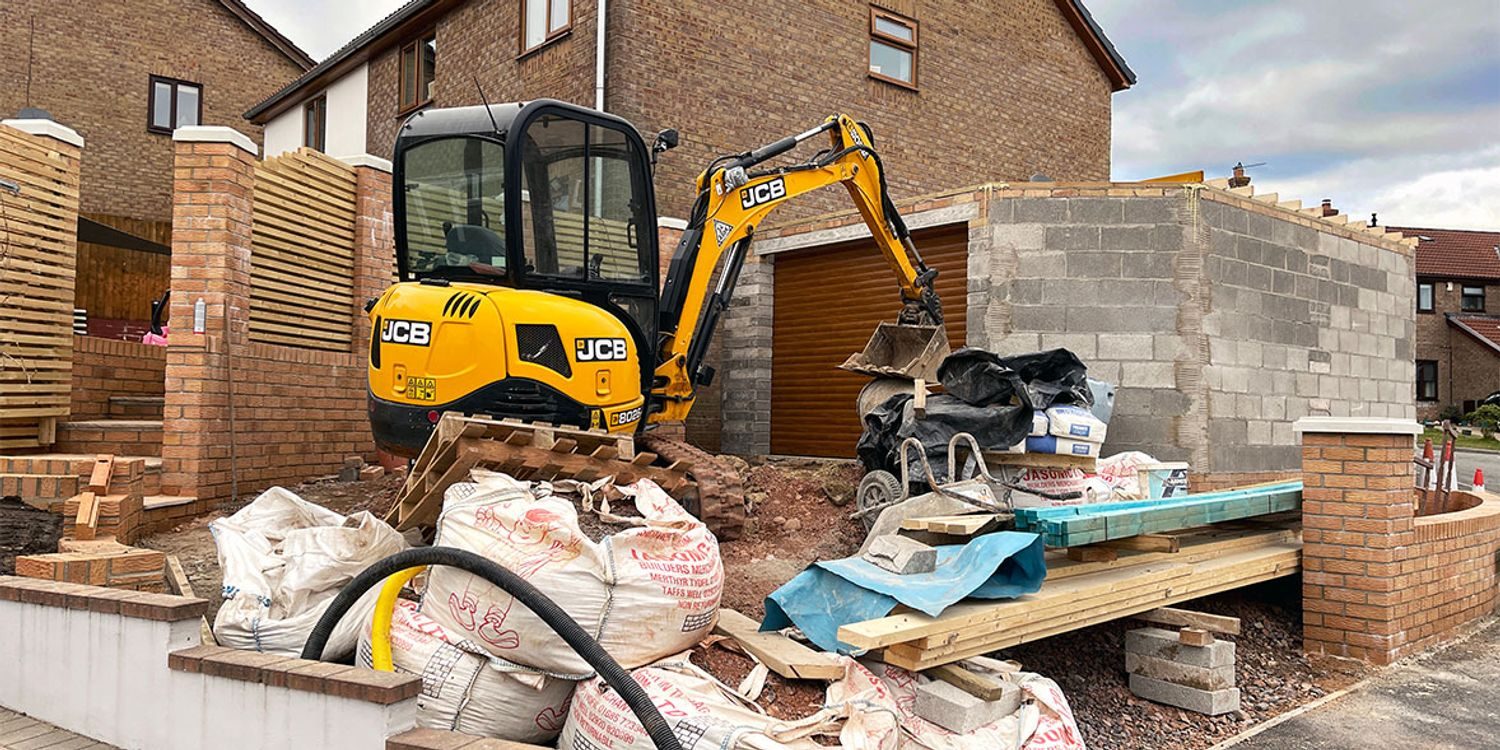 Imprescape digger and team mid-build on a rear extension